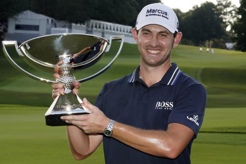 Patrick Cantlay poses with the trophy after winning the Tour Championship.