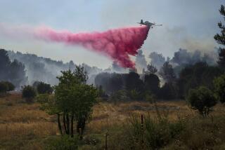 A plane uses a fire retardant to extinguish a fire burning in an area near the border with Lebanon, in Safed, northern Israel, Wednesday, June 12, 2024. Scores of rockets were fired from Lebanon toward northern Israel on Wednesday morning, hours after Israeli airstrikes killed four officials from the militant Hezbollah group including a senior military commander. (AP Photo/Leo Correa)