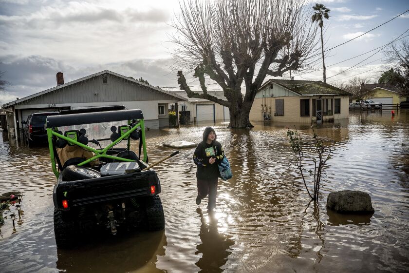 FILE - Brenda Ortega, 15, salvages items from her flooded Merced, Calif., home on Tuesday, Jan. 10, 2023. In California, only about 230,000 homes and other buildings have flood insurance policies, which are separate from homeowners insurance. (AP Photo/Noah Berger, File)