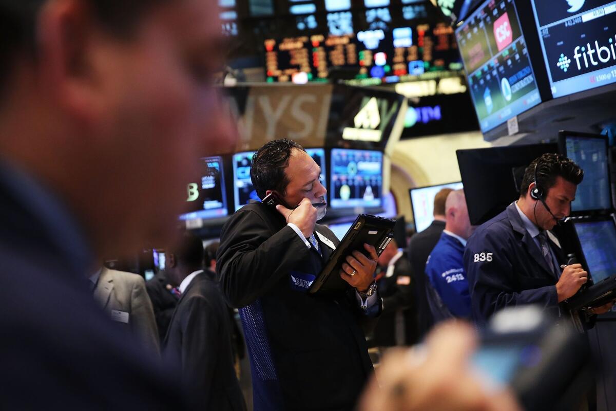 Traders work on the floor of the New York Stock Exchange on Monday.