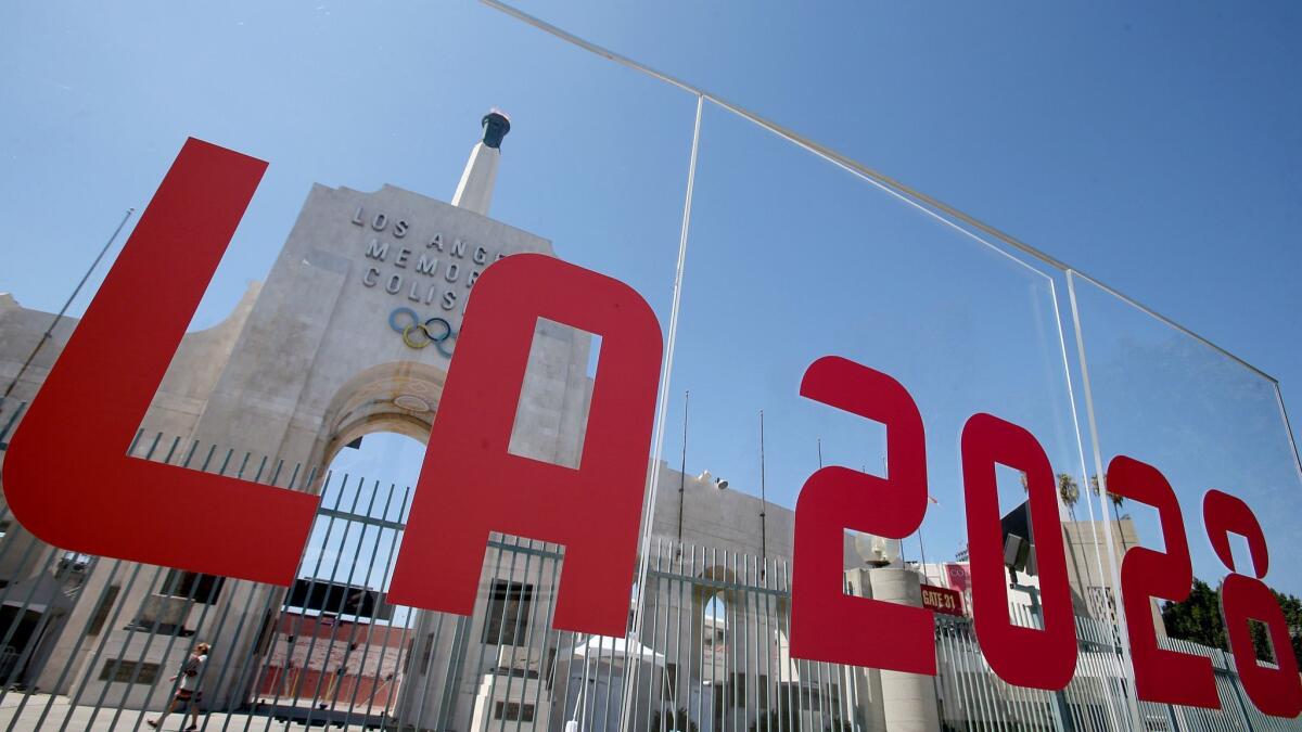 The Coliseum framed by a plexiglass sign after the city was officially awarded the rights to host the 2028 Olympic Games on Sep. 13, 2017.