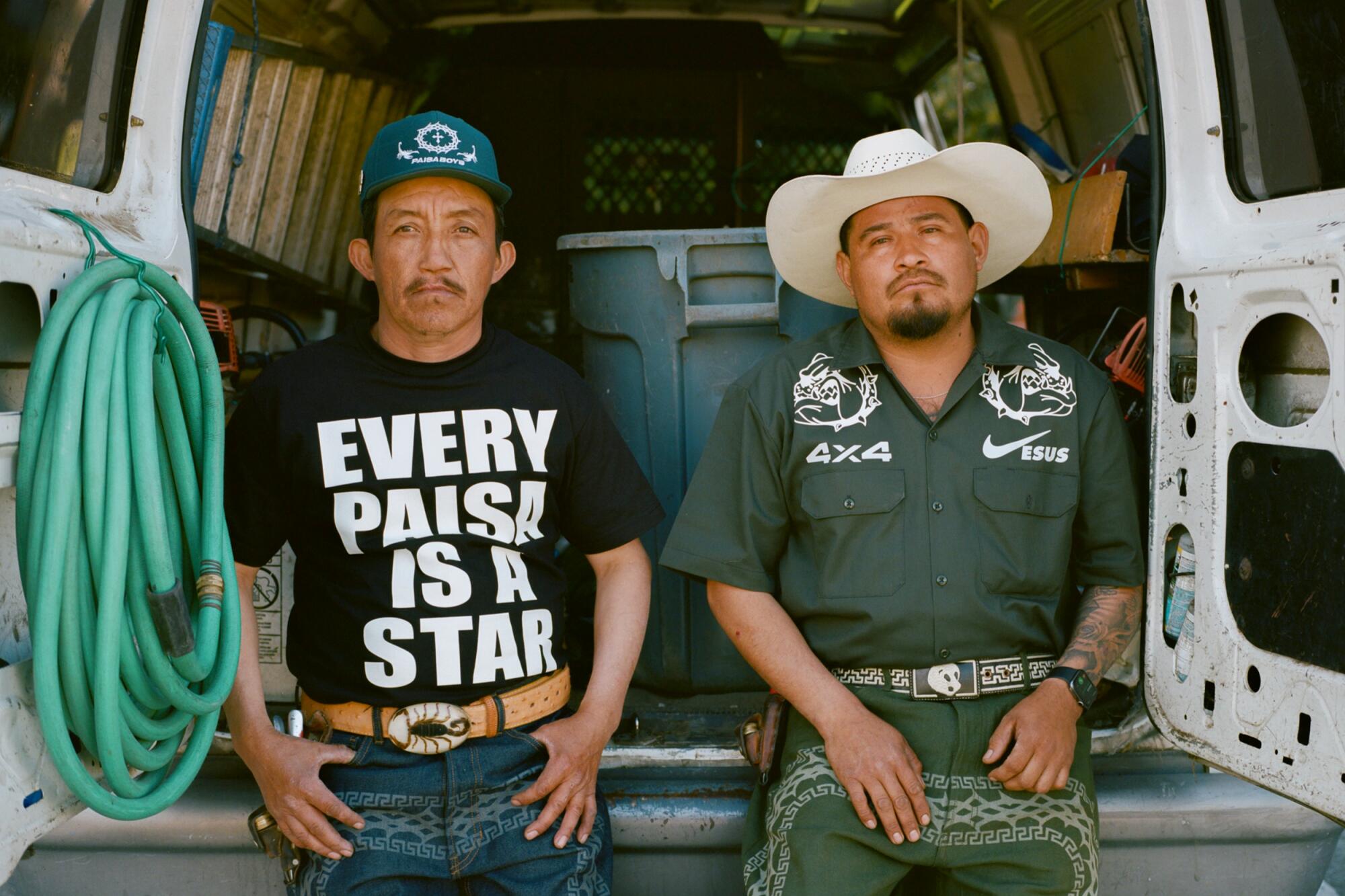Photo of two landscapers standing in front of a truck, dressed in Paisaboys clothes.