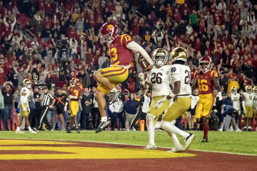 USC quarterback Caleb Williams runs for his third touchdown of the game against Notre Dame on Nov. 26, 2022.