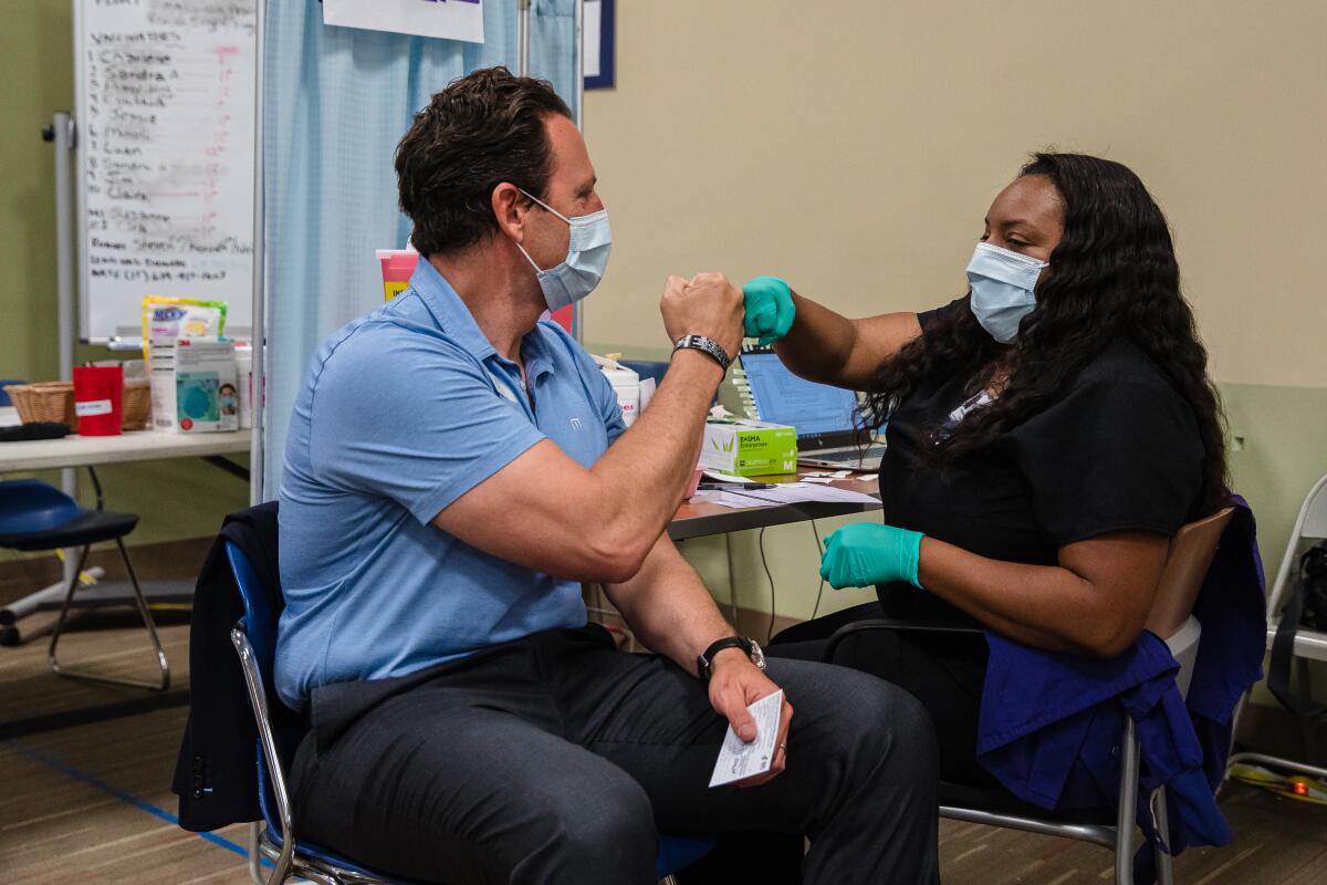 County Supervisor Nathan Fletcher gives Charlene Plummer, BSN, Registered Nurse a fist bump.