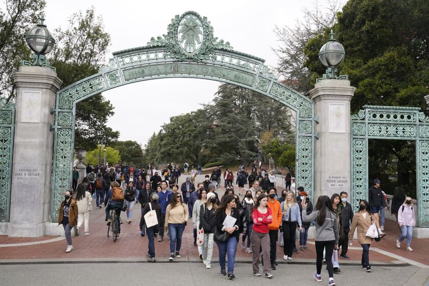 Students make their way through the Sather Gate near Sproul Plaza on the University of California, Berkeley, campus Tuesday, March 29, 2022, in Berkeley, Calif. (AP Photo/Eric Risberg)
