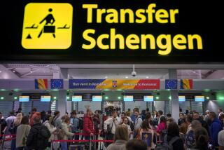 Passengers arriving at the Henri Coanda International Airport pass under a Schengen Information sign, in Otopeni, near Bucharest, Romania, Sunday, March 31, 2024. Romania and Bulgaria joined Europe's passport- and visa-free Schengen Area, applying only to travelers arriving by air and sea. (AP Photo/Andreea Alexandru)