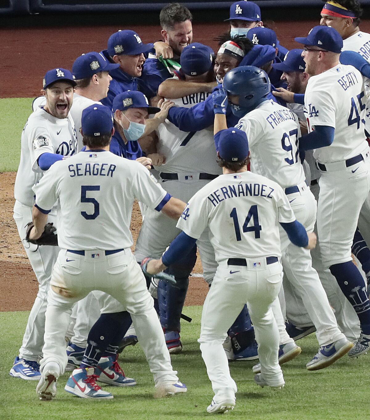 Julio Urias is mobbed by teammates after the World Series Game 6 victory.
