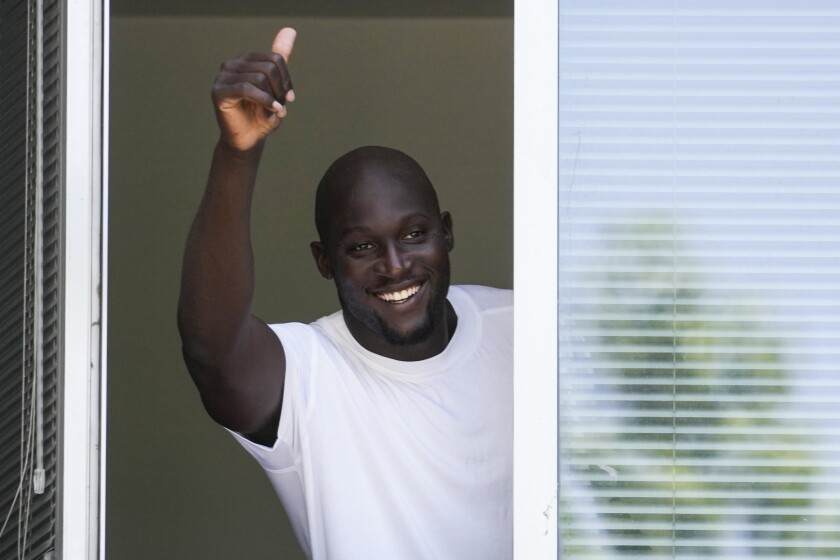 Soccer player Romelu Lukaku of Belgium gives his thumbs up as he salutes Inter Milan supporters from a window of the Italian Olympic Committee's headquarters in Milan, Italy, Wednesday, June 29, 2022. Lukaku is undergoing medical tests before transferring back to Inter from Chelsea. (AP Photo/Luca Bruno)