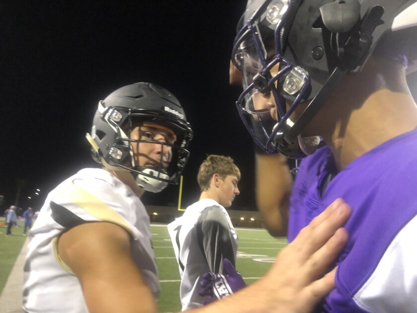 Calabasas quarterback Jaden Casey (left) congratulates Rancho Cucamonga quarterback CJ Stroud after the Coyotes' 45-26 victory. Both senior quarterbacks have stayed at the same high school for four years.