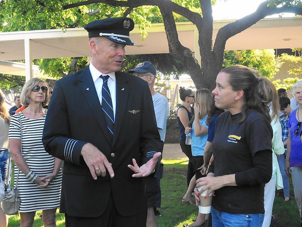 American Airlines pilot Jeff Diercksmeier talks with Johannah Falke at the Patriot Day ceremony Friday at Costa Mesa City Hall. A crowd of 150 came to the ceremony that recognized the 14th anniversary of the Sept. 11, 2001, terrorist attacks on the East Coast.
