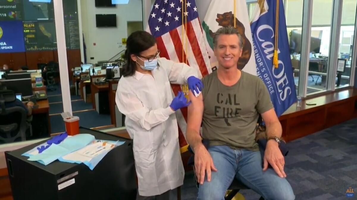 In this image taken from live streamed video from the California Governor's Office, California Gov. Gavin Newsom getting a flu shot during a news conference on Monday, Sept. 28, 2020, in Rancho Cordova, Calif. Newsom said he has gotten a flu shot every year "for as long as I can remember." He said it's important to get a flu shot this year to ensure hospitals are not overrun by a combination of flu and coronavirus cases. While California's coronavirus cases have been decreasing over the last several weeks, Newsom said Monday there is "some concern" that cases could increase over the next few weeks. (California Governor's Office via AP))