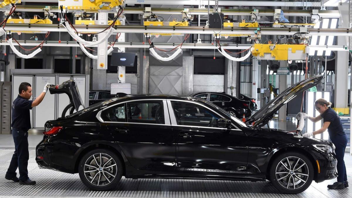 BMW employees work on a 3 Series sedan at the company's new factory in San Luis Potosi, Mexico.
