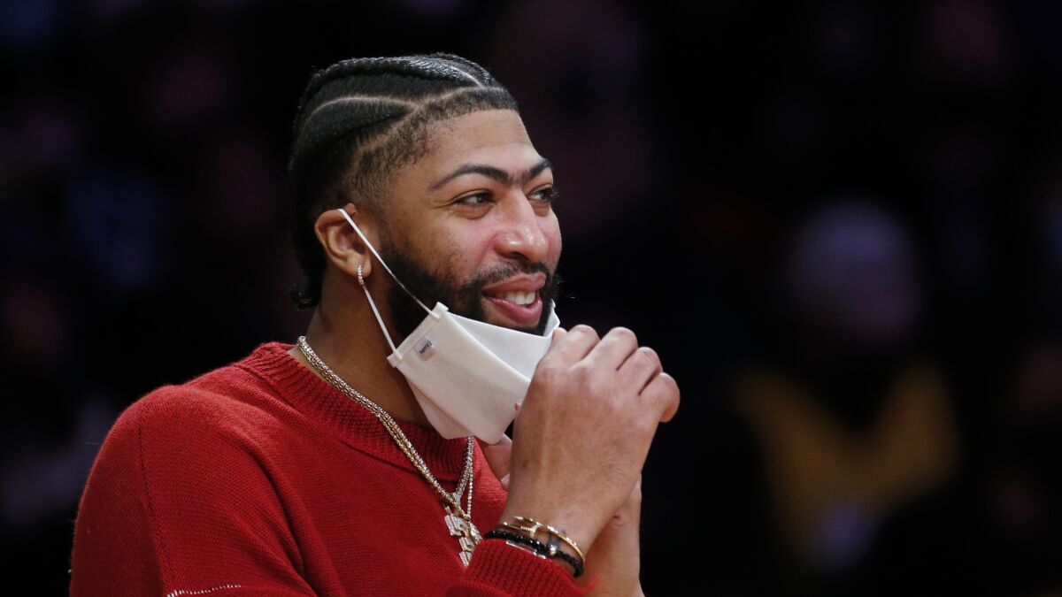 Lakers forward Anthony Davis watches from the bench.