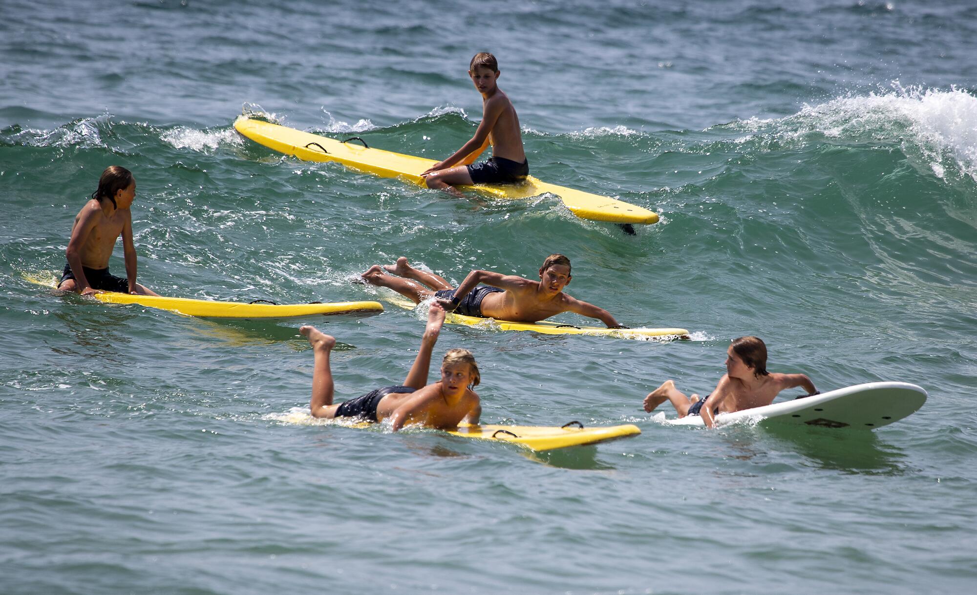 Los Angeles County junior lifeguards paddle for a wave