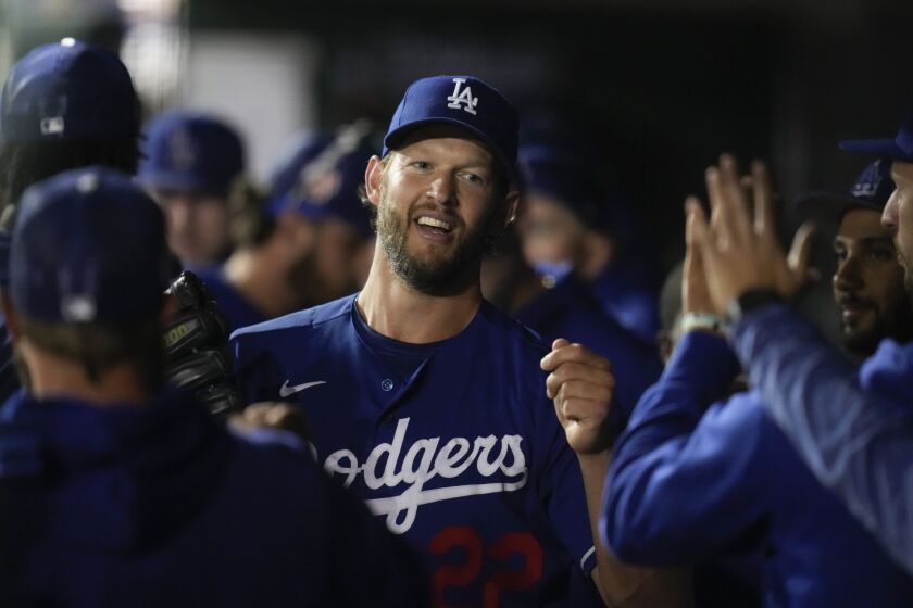 Los Angeles Dodgers starting pitcher Clayton Kershaw (22) returns to the dugout after being pulled from the mound during the fourth inning of a spring training baseball game against the Texas Rangers in Glendale, Ariz., Thursday, March 16, 2023. (AP Photo/Ashley Landis)