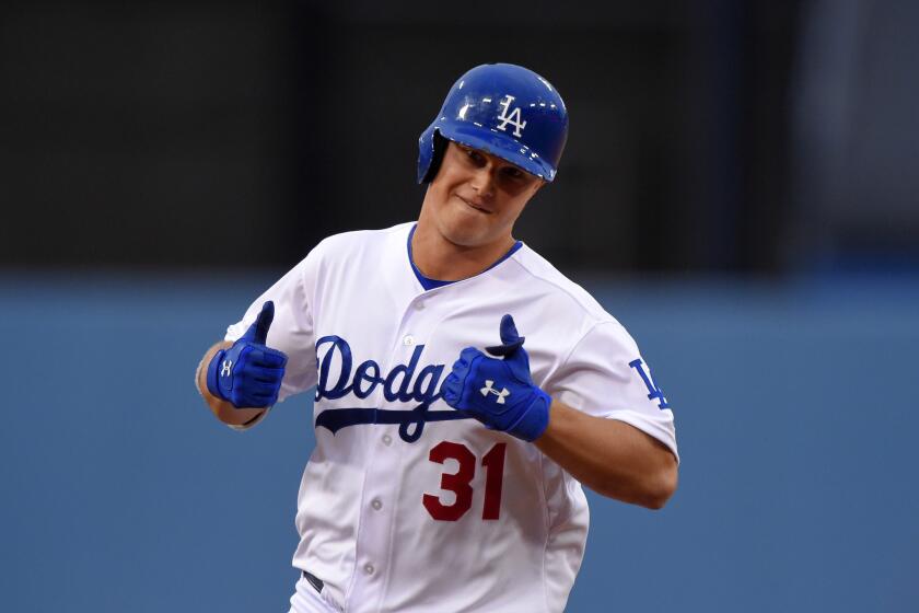 Dodgers outfielder Joc Pederson gives two thumbs up after his solo home run in the first inning Saturday against San Diego.