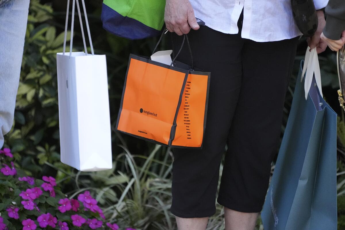 Shoppers carry their purchases