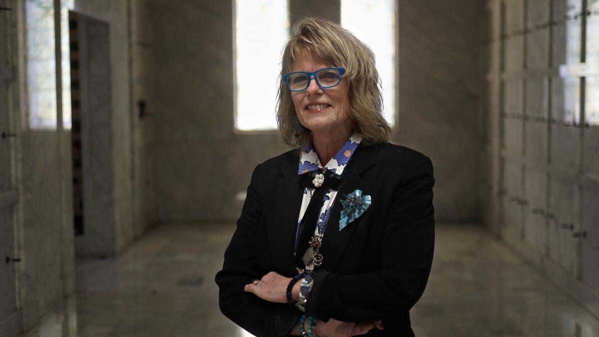 Jill Ann Lloyd, a funeral celebrant and service director, poses for a portrait in the mausoleum at Fairhaven Memorial Park Mortuary in Santa Ana on Jan. 22, 2019.