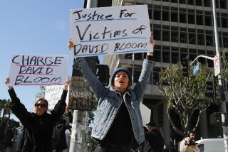 Los Angeles, CA, Thursday, March 2, 2023 - Victims of David Bloom, the one-time Wall Street Whiz Kid financial scammer, protest outside D.A. Gascon's office demanding that charges be filed. Bloom's ex-wife Nancy Ozeas, left and Caroline D'Amore at the protest. (Robert Gauthier/Los Angeles Times)