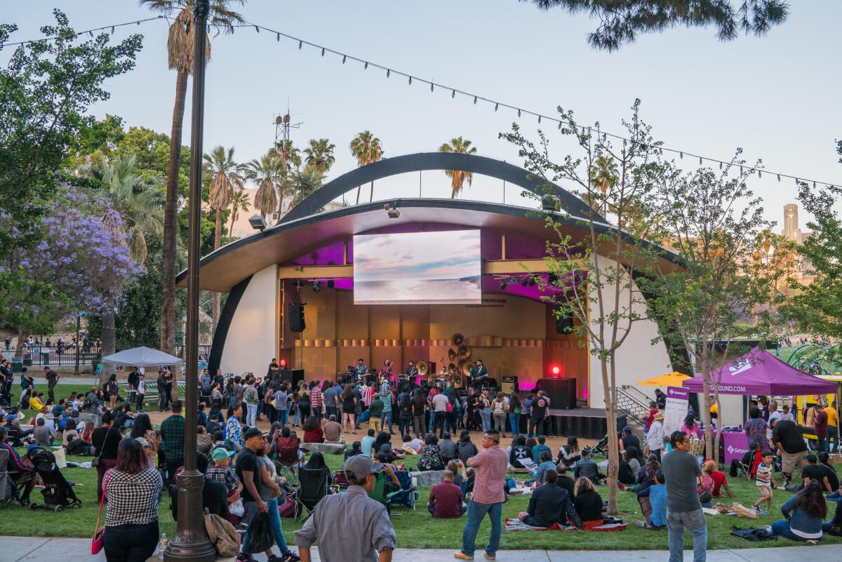A packed stage and event-goers on the grass at Levitt Pavilion in MacArthur Park.