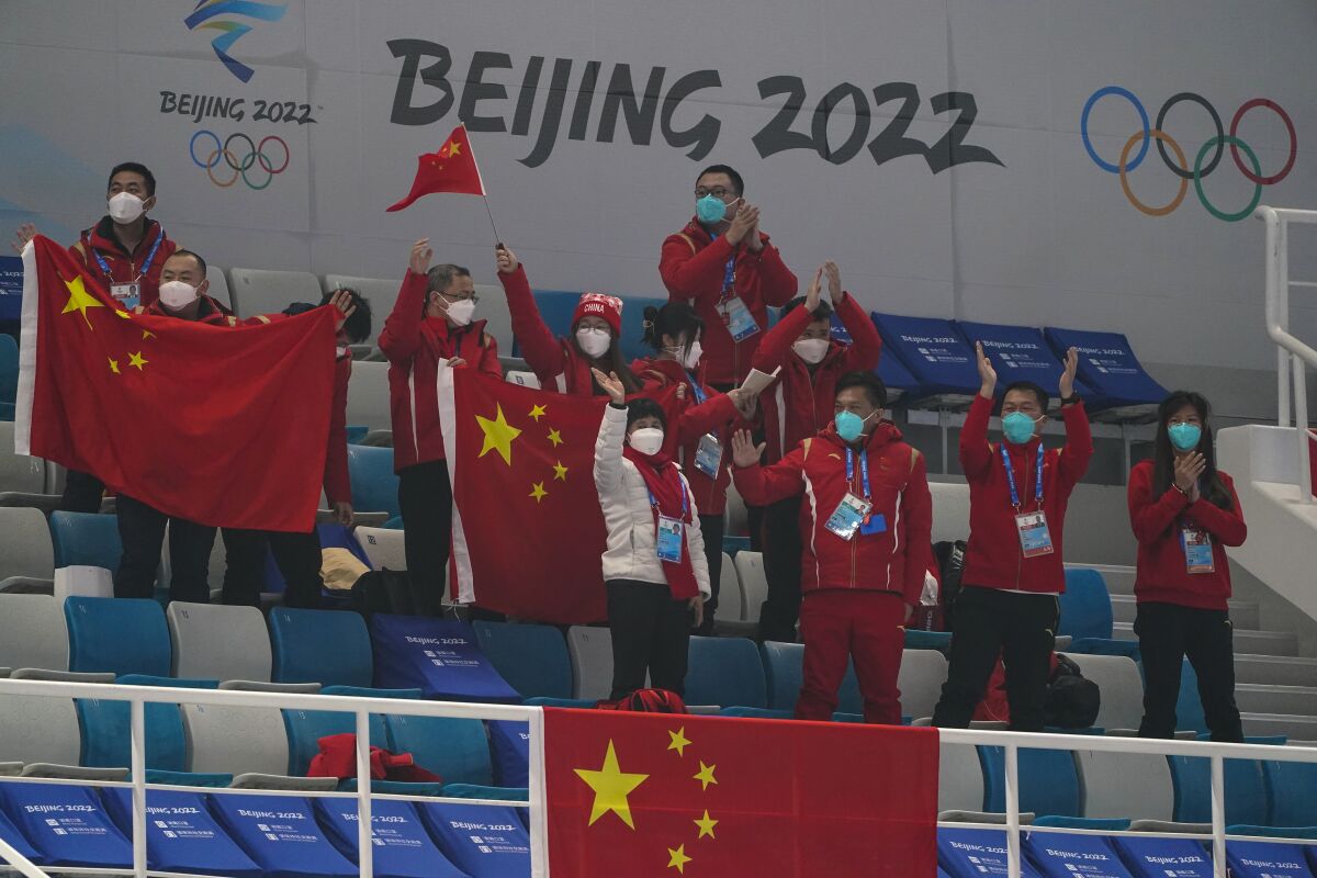 Chinese fans cheer after a China win against Australia during the mixed doubles curling match at the Beijing Winter Olympics Thursday, Feb. 3, 2022, in Beijing. (AP Photo/Brynn Anderson)