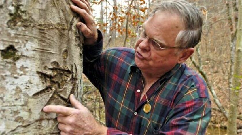 CODE: Bob Brewer points out arcane symbols on a tree in western Arkansas that he believes are clues to a treasure stashed away by the Knights of the Golden Circle, a secretive Confederate group.
