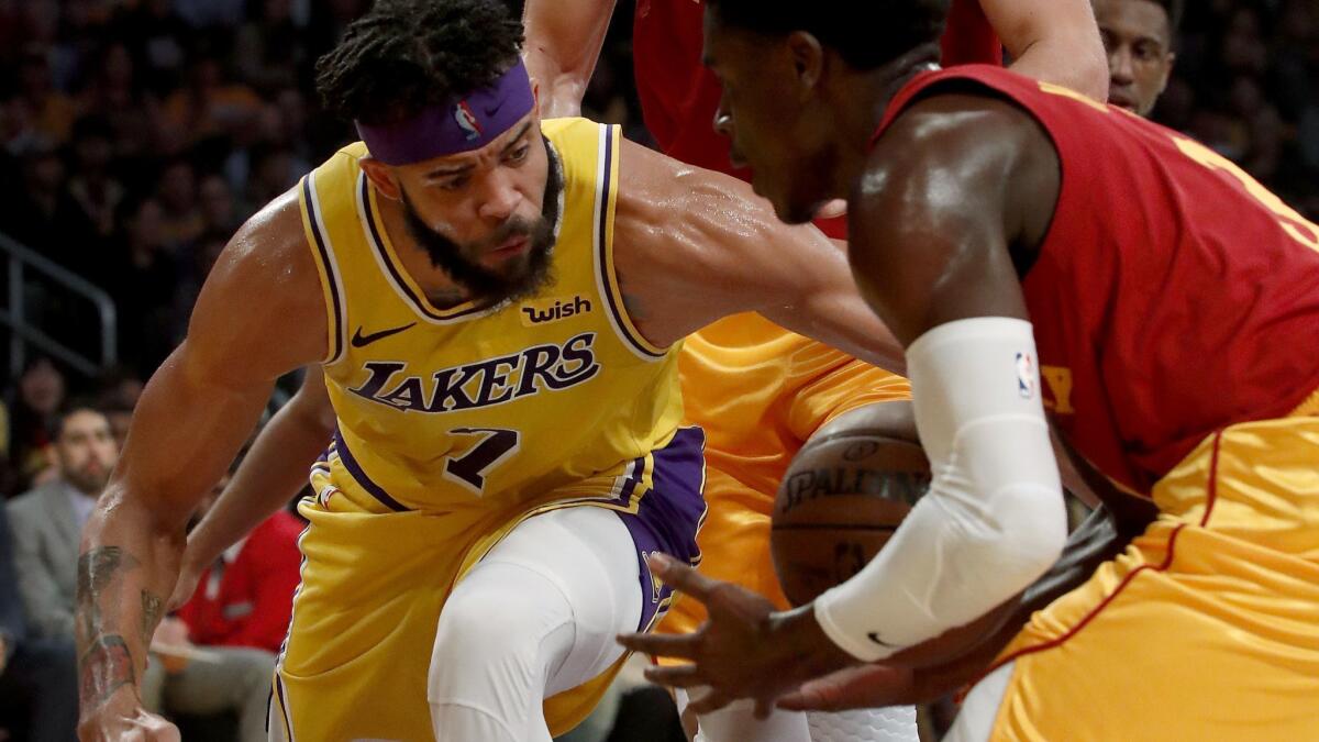 Lakers center JaVale McGee, who had four blocked shots, fights for control of the ball with Pacers guard Aaron Holiday during the second quarter Thursday.