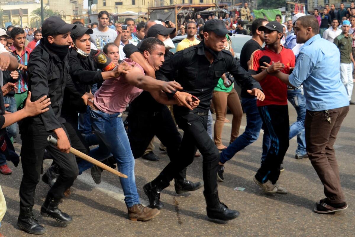Egyptian police arrest a supporter of ousted President Mohamed Morsi during a protest in Cairo in November. Allegations of abuse in Egyptian jails are mounting.