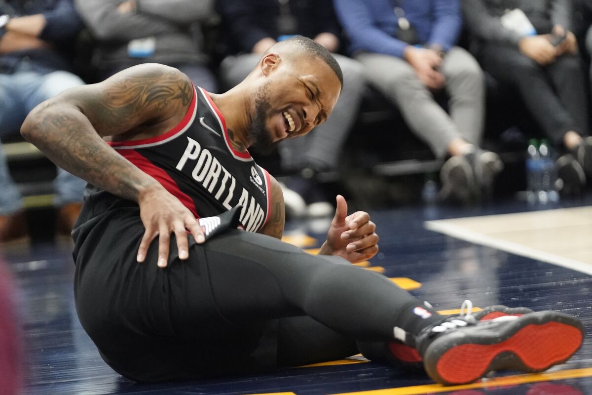 Portland Trail Blazers guard Damian Lillard reacts after being fouled in the first half during an NBA basketball game against the Utah Jazz, Monday, Nov. 29, 2021, in Salt Lake City. (AP Photo/Rick Bowmer)