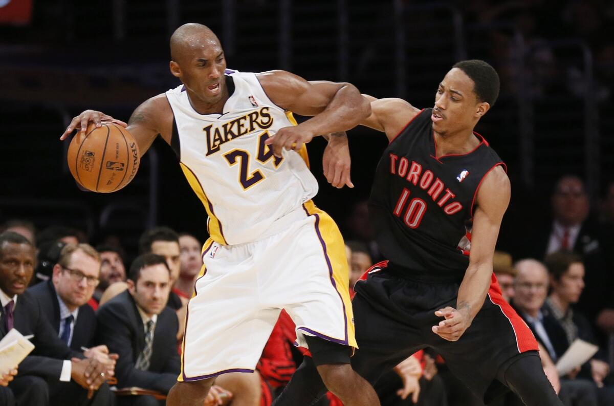 Kobe Bryant is defended by Raptors guard DeMar DeRozan, who grew up in Los Angeles idolizing the Lakers great.