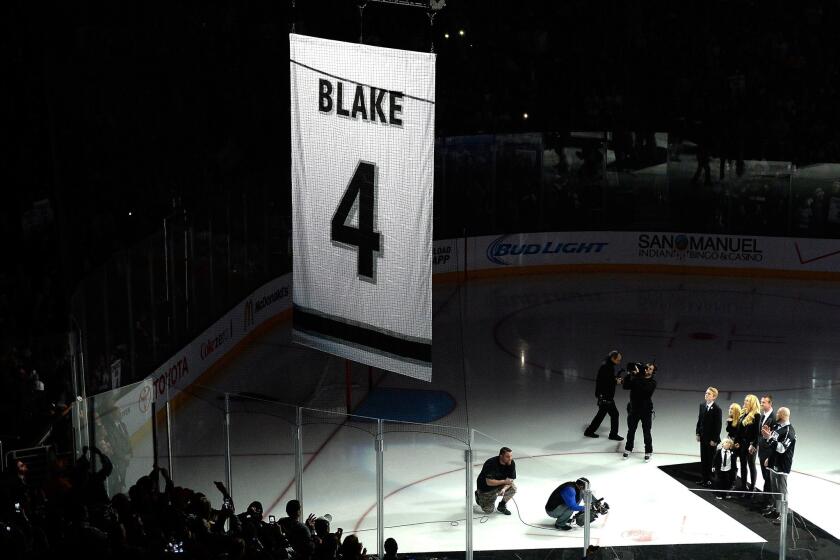Rob Blake watches along with family members as a banner with his Kings jersey number is raised at Staples Center.