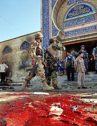 Blood is seen in front of the Bratha mosque today in Baghdad. Three suicide bombers dressed as women blew themselves up in this key Shiite mosque where people were gathering for Friday prayer, killing at least 78 and wounding 154.