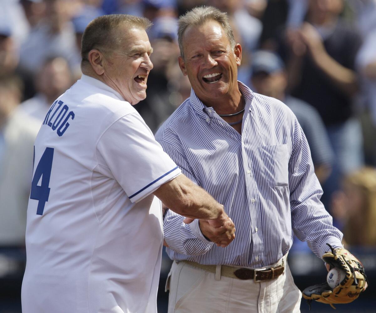 Royals Hall of Fame members Whitey Herzog, left, and George Brett shake hands after the first pitch ceremony.