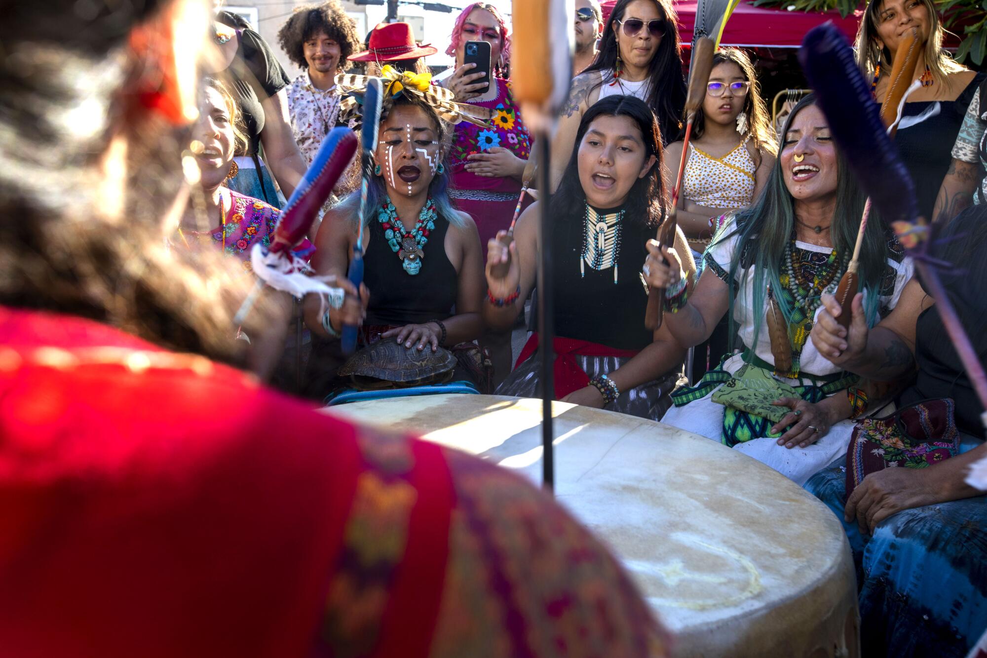 Members of Winds of the South perform a drum ceremony