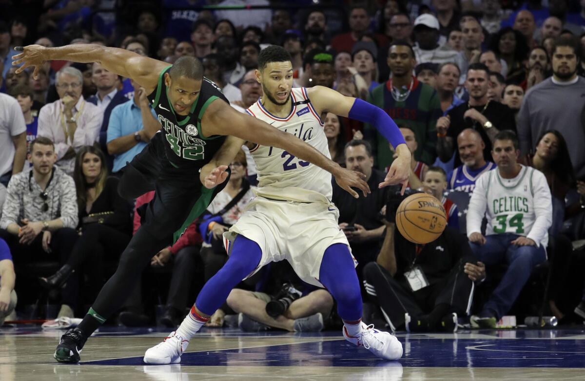 Celtics center Al Horford tries to steal the ball from 76ers forward Ben Simmons during Game 3 of their playoff series.