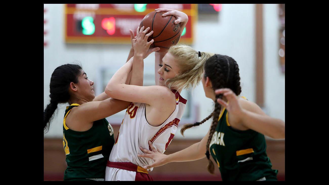 Ocean View High School girls’ basketball player Helen Reynolds battles for the ball in the Premiere Flight championship game of the Hawk Holiday Classic vs. Saddleback High School at Ocean View High School in Huntington Beach on Saturday, Dec. 8, 2018. Reynolds was named MVP.