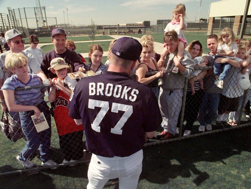 Garth Brooks, a nonroster invitee to the San Diego Padres spring training camp, signs autographs following a 1999 workout.