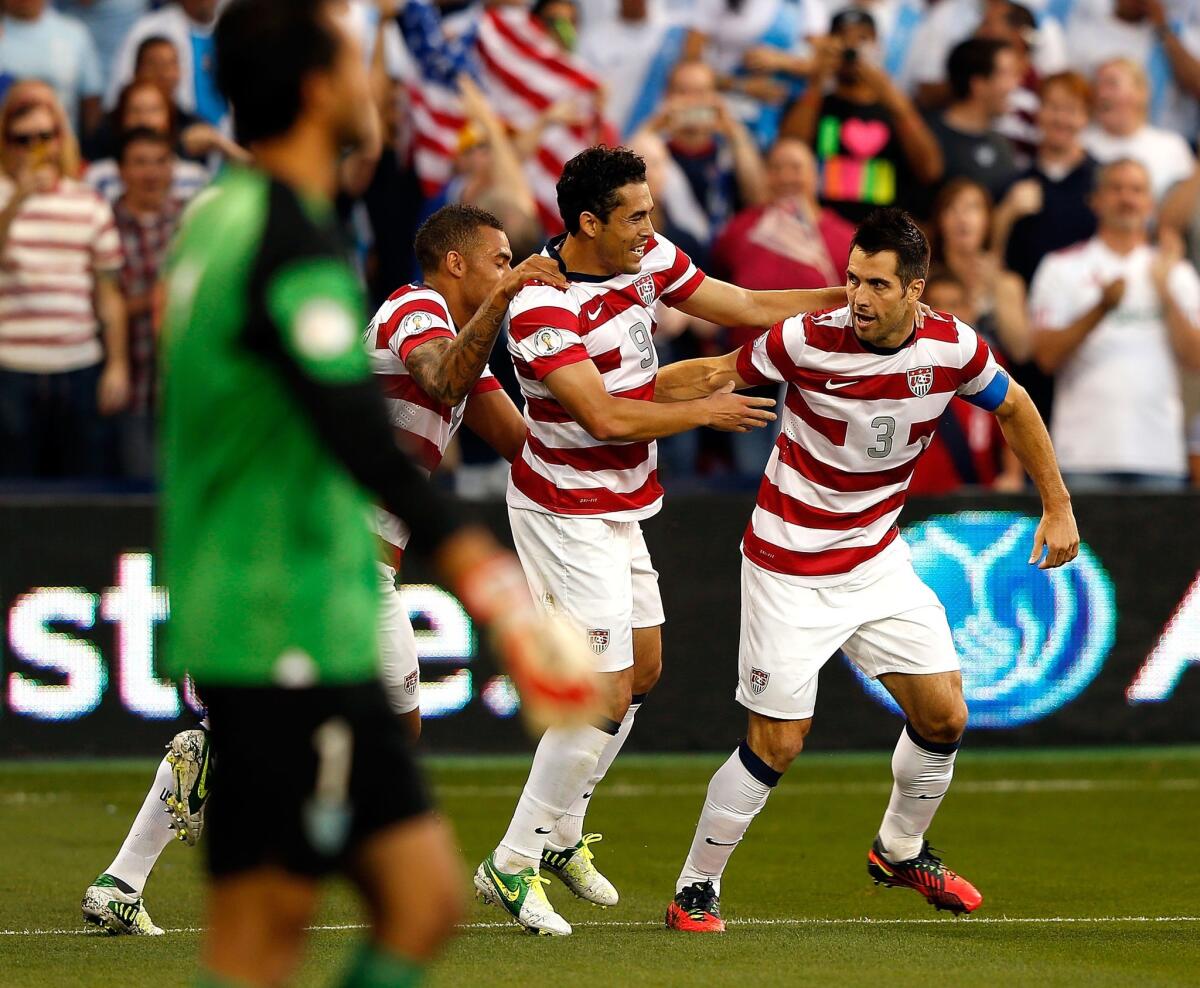 Carlos Bocanegra, right, celebrates with his U.S. teammates after scoring a goal during a World Cup qualifying match against Guatemala in 2012. Bocanegra announced Thursday he intends to retire following the MLS season.