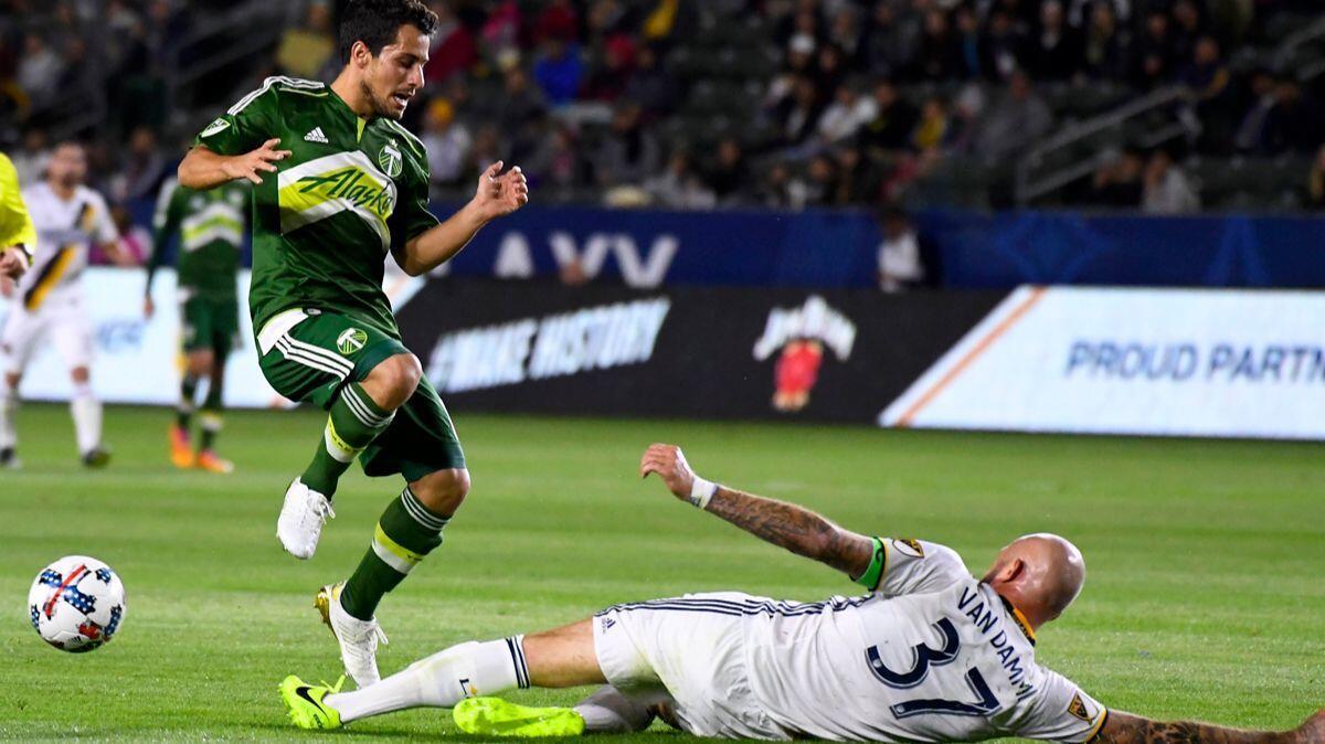 Galaxy defender Jelle Van Damme, right, knocks the ball away from Portland Timbers midfielder Sebastian Blanco during the first half of a preseason game in February.