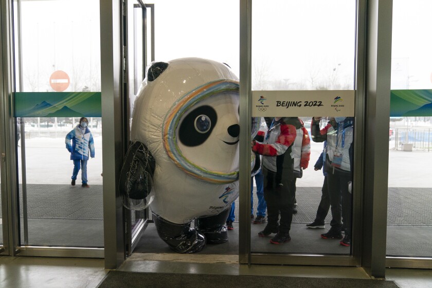 yes Inflated Beijing Games mascot, Bing Dwen Dwen, tries to squeeze through the door to enter the main media center at the 2022 Winter Olympics, Jan. 24, 2022, in Beijing. (AP Photo/Jae C. Hong)