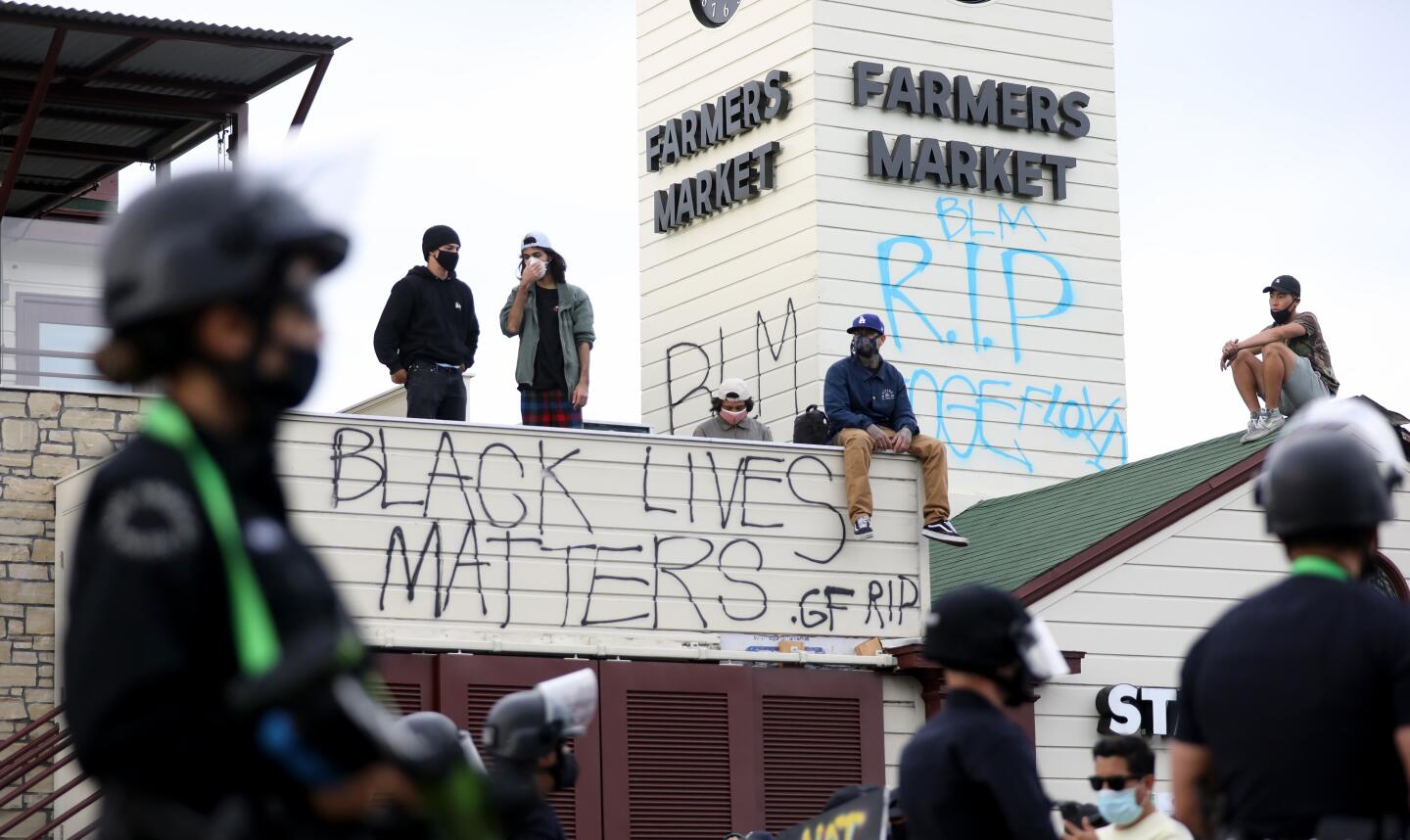 Los Angeles police contain protesters at the Farmers Market