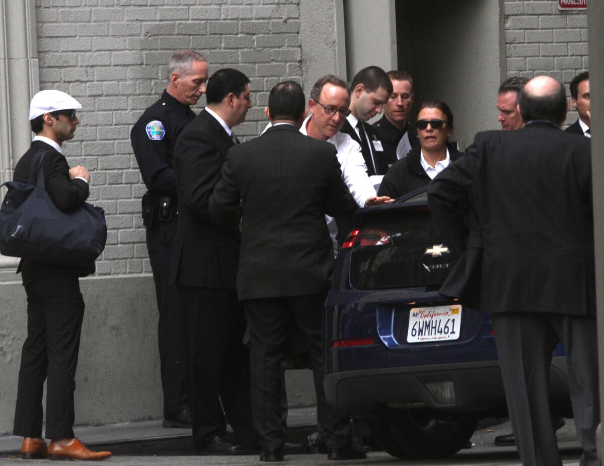 People arrive at Harlem Place alley near 7th and Spring streets for a private downtown event to hear a convicted ex-member of the Mexican Mafia speak to a group of business leaders and local police chiefs.