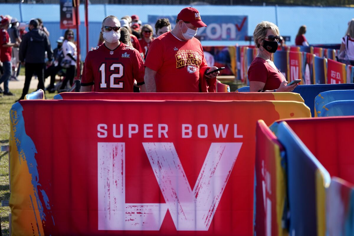 Fans arrive at Raymond James Stadium in Tampa, Fla., ahead of Super Bowl LV.
