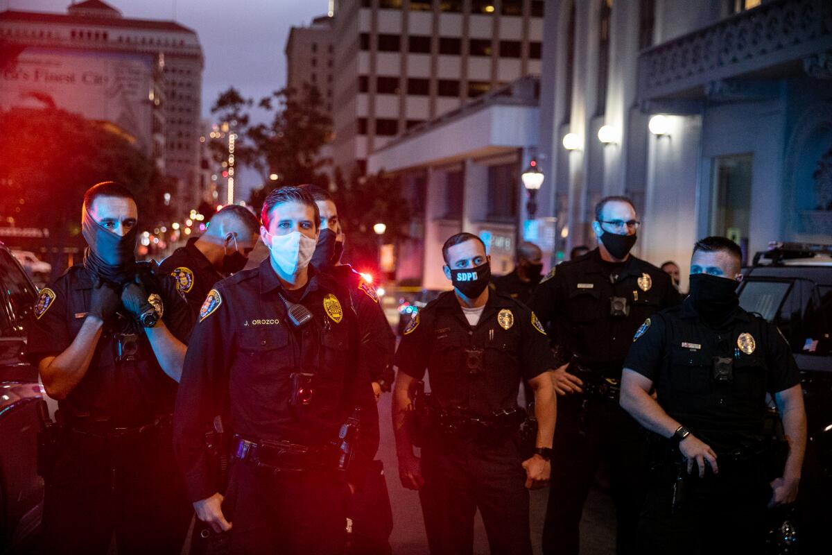 SDPD officers stand guard on Sixth Avenue in Downtown San Diego where San Diego Police Department officers shot a man.