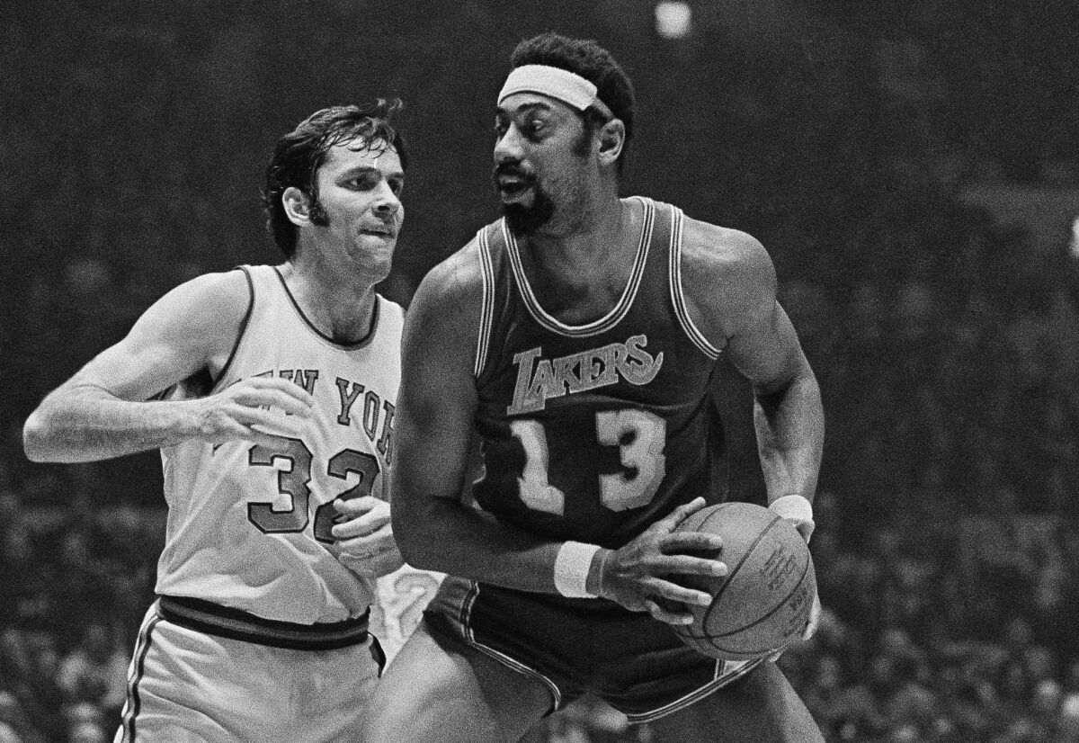 Lakers star Wilt Chamberlain looks to pass during a game against the New York Knicks in February 1972.
