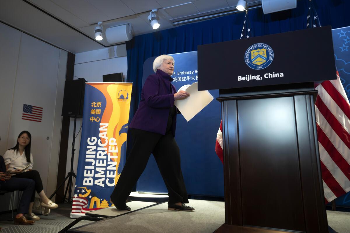 Janet Yellen walks to a lectern in Beijing.