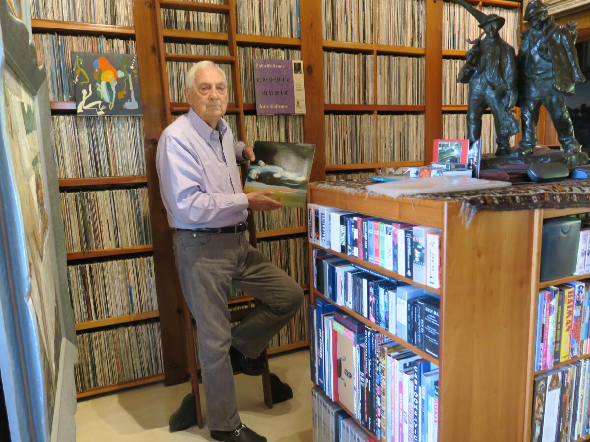 Bram Dijkstra is shown with some of his nearly 50,000 albums. 
