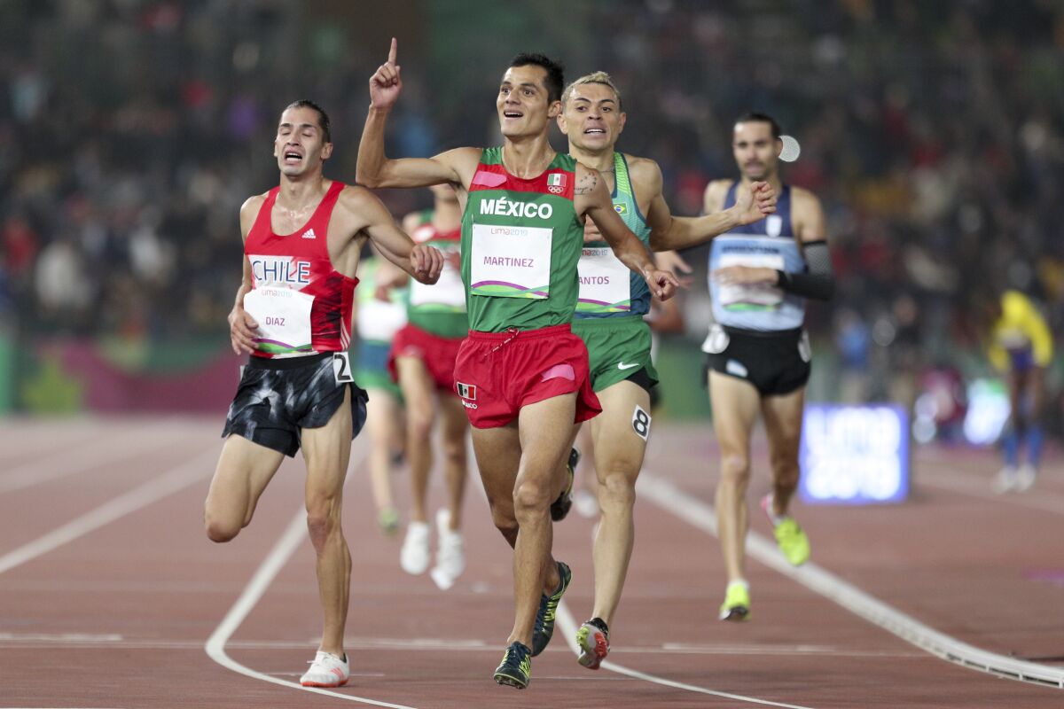 Fernando Martinez of Mexico celebrates winning the gold medal in the men's 5000m during the athletics final at the Pan American Games in Lima, Peru, Tuesday, Aug. 6, 2019. (AP Photo/Martin Mejia)