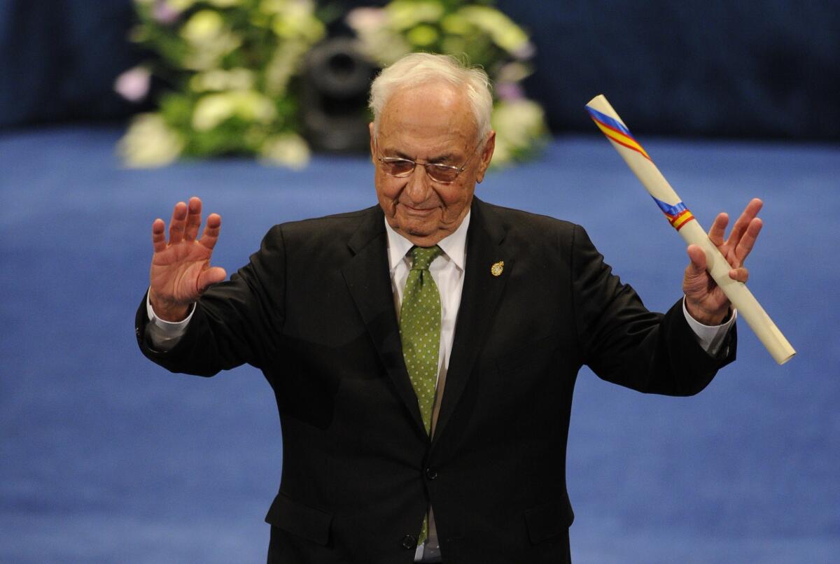 Architect Frank Gehry celebrates on the stage after receiving the2014 Prince of Asturias Award for Arts from Spain's King Felipe in Oviedo on Friday.