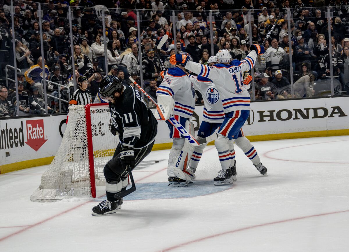 Kings captain Anze Kopitar skates away as the Edmonton Oilers celebrate.